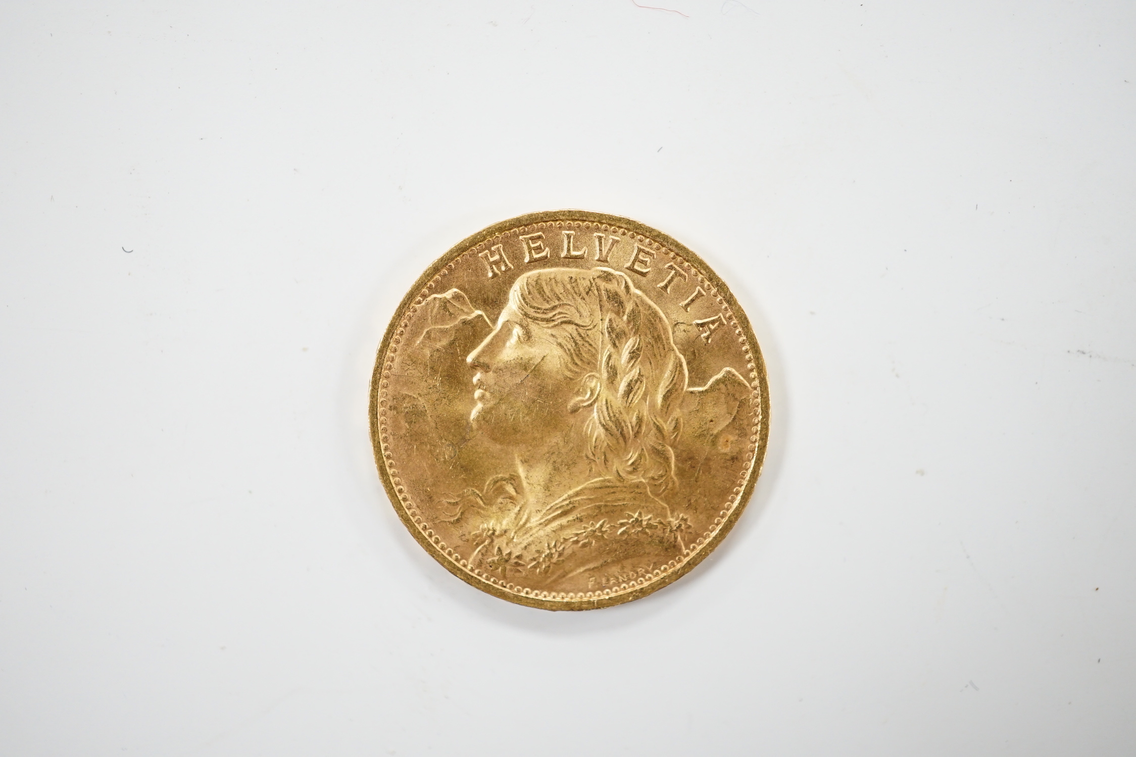 A Swiss 1947 gold 20 franc Helvetia coin.